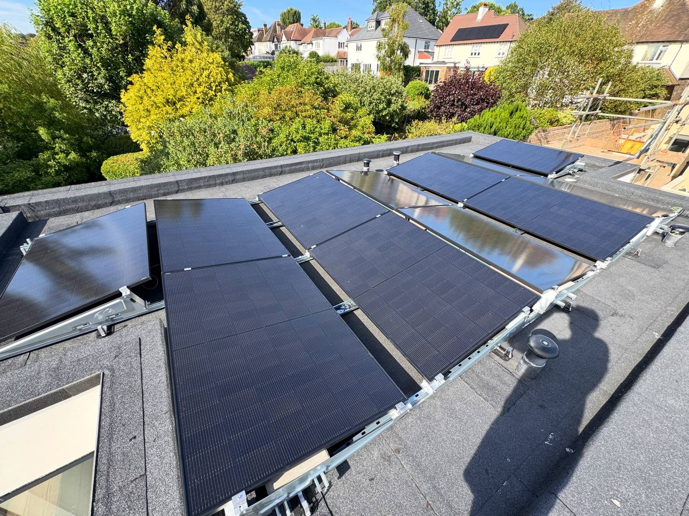 Rows of black solar PV panels on a flat roof, installed by LH Electrical