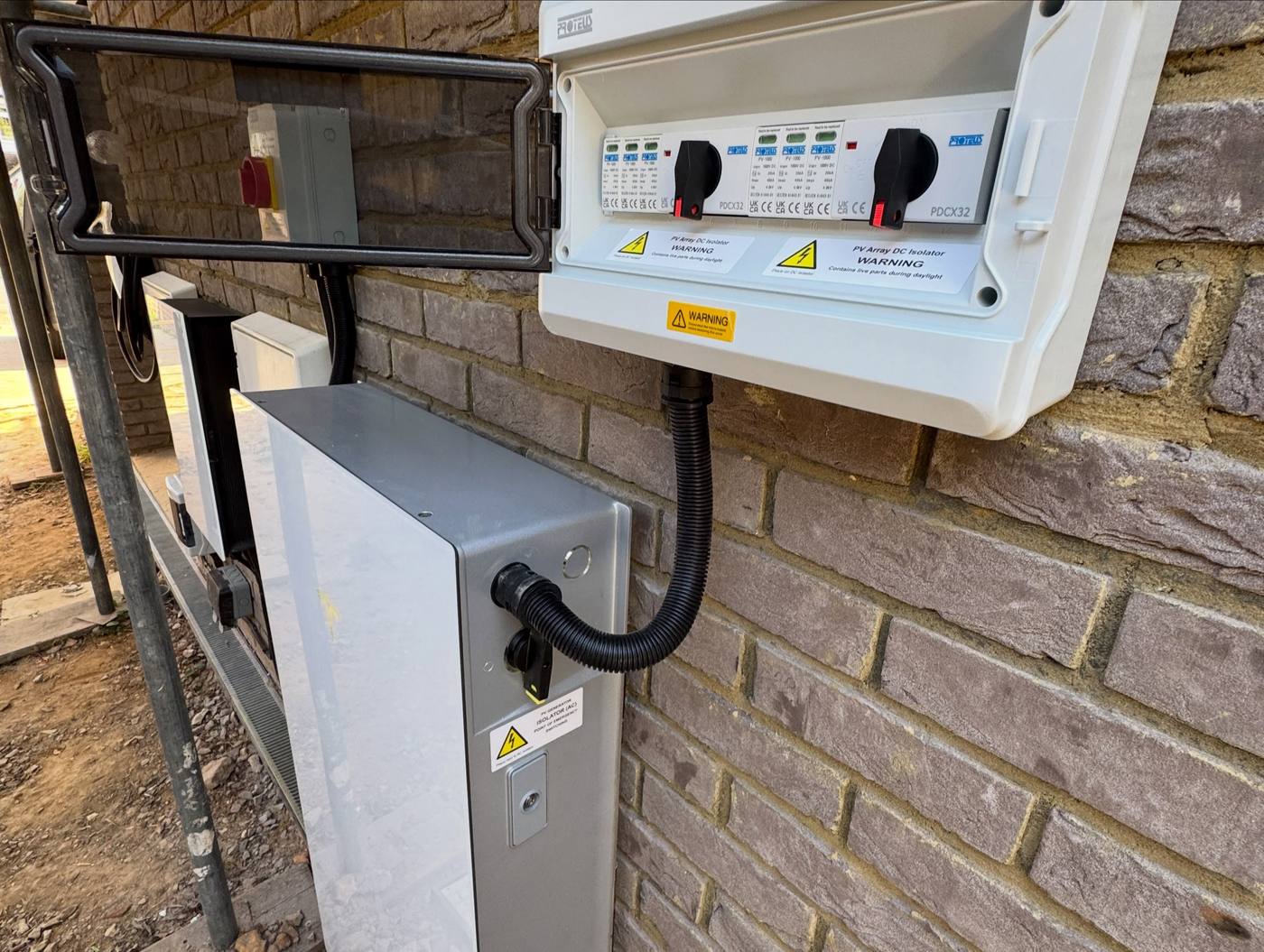 PV array DC isolator enclosure and generation equipment fitted on an exterior wall